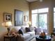 Inviting living room with a balcony, comfortable couch and chair, hardwood floors, and stylish decor at 711 Cosmopolitan Ne Dr # 123, Atlanta, GA 30324