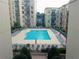 Outdoor pool surrounded by lounge chairs in a multi-story building complex at 711 Cosmopolitan Ne Dr # 123, Atlanta, GA 30324