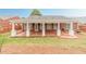 Exterior home view featuring a covered patio and grass at 1022 Pecan Grove Pl, Lawrenceville, GA 30046