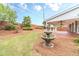 Lush backyard featuring a fountain, flowers, and covered patio at 1022 Pecan Grove Pl, Lawrenceville, GA 30046