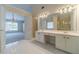 Bathroom featuring double vanity, soaking tub, and separate shower, connected to a carpeted room at 1022 Pecan Grove Pl, Lawrenceville, GA 30046