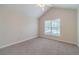 Bedroom showcasing vaulted ceilings, carpeted floors and a large window for ample natural light at 1022 Pecan Grove Pl, Lawrenceville, GA 30046