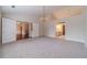 Spacious bedroom featuring carpet flooring, chandelier, and access to bathroom at 1022 Pecan Grove Pl, Lawrenceville, GA 30046
