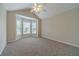 Bright bedroom featuring neutral walls, plush carpeting, and a bay window at 1022 Pecan Grove Pl, Lawrenceville, GA 30046