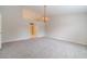 Large bedroom featuring carpet flooring, chandelier, and open doorway at 1022 Pecan Grove Pl, Lawrenceville, GA 30046