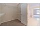 Walk-in closet showing adjustable shelving with carpeted floor, located off of the bathroom at 1022 Pecan Grove Pl, Lawrenceville, GA 30046