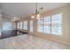 Bright dining area with tile floors, pendant lighting, and multiple windows for natural light at 1022 Pecan Grove Pl, Lawrenceville, GA 30046