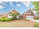 Beautiful one-story red brick home with well-manicured landscaping and attached two car garage at 1022 Pecan Grove Pl, Lawrenceville, GA 30046