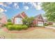 Beautiful one-story red brick home with well-manicured landscaping and attached two car garage at 1022 Pecan Grove Pl, Lawrenceville, GA 30046