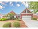 Charming brick home with manicured landscaping, a two-car garage, and inviting curb appeal at 1022 Pecan Grove Pl, Lawrenceville, GA 30046