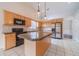 Well-equipped kitchen with island, stainless appliances, and adjacent dining area at 1022 Pecan Grove Pl, Lawrenceville, GA 30046