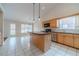 Open-concept kitchen featuring an island, modern appliances, and views to the outdoors at 1022 Pecan Grove Pl, Lawrenceville, GA 30046