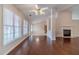 Bright living area with hardwood floors, large windows, and access to the kitchen at 1022 Pecan Grove Pl, Lawrenceville, GA 30046