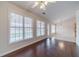 Living room with hardwood floors, large windows, and view of the kitchen at 1022 Pecan Grove Pl, Lawrenceville, GA 30046