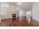 Open-concept living room featuring hardwood floors, fireplace, and easy access to entry at 1022 Pecan Grove Pl, Lawrenceville, GA 30046