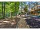 Picturesque backyard with winding stone paths and mature trees, offering privacy and tranquility at 1585 Lazy River Ln, Sandy Springs, GA 30350