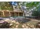 Beautifully landscaped backyard with a patio, lush greenery, and manicured gardens at 1585 Lazy River Ln, Sandy Springs, GA 30350