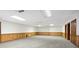 Large basement with paneled walls, carpet, and multiple doors at 1585 Lazy River Ln, Sandy Springs, GA 30350