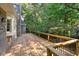 Large wooden deck surrounded by mature trees and lush greenery at 1585 Lazy River Ln, Sandy Springs, GA 30350
