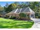 Charming brick home with side entry garage, mature trees, and professional landscaping at 1585 Lazy River Ln, Sandy Springs, GA 30350