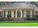 Charming brick home featuring a well-manicured front yard and inviting double door entrance at 1585 Lazy River Ln, Sandy Springs, GA 30350