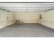 Spacious garage with epoxy flooring, paneled walls, and updated door mechanics at 1585 Lazy River Ln, Sandy Springs, GA 30350