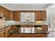 Kitchen with wood cabinets, large center island and black appliances at 1585 Lazy River Ln, Sandy Springs, GA 30350
