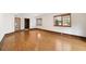 Open-plan living room featuring gleaming hardwood floors and sun-filled windows at 1585 Lazy River Ln, Sandy Springs, GA 30350