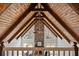 Vaulted living room featuring wood beams, stone fireplace, and a fan at 1585 Lazy River Ln, Sandy Springs, GA 30350
