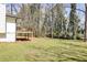 Expansive backyard with a raised wooden deck, offering a serene and private outdoor space at 1598 Kings Rd, Marietta, GA 30062