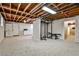 Spacious basement featuring a small kitchen, work-out equipment and carpeted floors at 1598 Kings Rd, Marietta, GA 30062