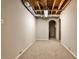 Carpeted basement with exposed ceiling and ductwork leading to a connected room at 1598 Kings Rd, Marietta, GA 30062