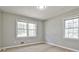 Well-lit bedroom with neutral walls and two windows providing ample natural light at 1598 Kings Rd, Marietta, GA 30062