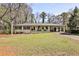 Attractive single-story home featuring a covered carport and beautiful landscaping at 1598 Kings Rd, Marietta, GA 30062
