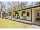 Inviting front porch with seating, hanging plants, and a covered carport area at 1598 Kings Rd, Marietta, GA 30062