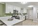 Modern kitchen features white cabinetry, stainless steel appliances, and plenty of counter space at 1598 Kings Rd, Marietta, GA 30062