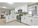 Bright kitchen boasts white cabinets, stainless steel appliances, and stylish countertops at 1598 Kings Rd, Marietta, GA 30062
