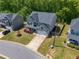 Aerial view of a home with a well-maintained lawn and a spacious driveway at 207 Cherokee Reserve Cir, Canton, GA 30115