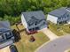 Aerial view of a two-story home with a dark roof and surrounding greenery at 207 Cherokee Reserve Cir, Canton, GA 30115