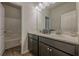 Contemporary bathroom featuring a dark vanity with double sinks, a white countertop and combination shower at 207 Cherokee Reserve Cir, Canton, GA 30115
