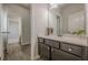Modern bathroom featuring a dark vanity with a white countertop and hardwood style floors at 207 Cherokee Reserve Cir, Canton, GA 30115