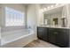 Modern bathroom with double sink vanity, large mirror, and stylish tile flooring at 207 Cherokee Reserve Cir, Canton, GA 30115