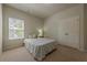 Neutral bedroom with carpet flooring, a window, and a simple wooden bedside table at 207 Cherokee Reserve Cir, Canton, GA 30115