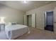 Cozy bedroom featuring neutral walls, carpet flooring, and a closet with bi-fold doors at 207 Cherokee Reserve Cir, Canton, GA 30115