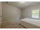 Simple bedroom design with carpet flooring and natural light from a window at 207 Cherokee Reserve Cir, Canton, GA 30115