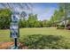 Community dog park with a dog waste station and well-maintained grassy area at 207 Cherokee Reserve Cir, Canton, GA 30115