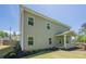 View of a two-story home with a covered patio and green siding at 207 Cherokee Reserve Cir, Canton, GA 30115