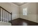 Welcoming foyer with dark hardwood floors, paneled walls, and a staircase leading to the upper level at 207 Cherokee Reserve Cir, Canton, GA 30115
