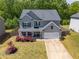 Well-maintained front yard with green grass and a charming two-story home at 207 Cherokee Reserve Cir, Canton, GA 30115