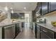 Modern kitchen with dark cabinets, granite countertops, stainless steel appliances, and an open layout at 207 Cherokee Reserve Cir, Canton, GA 30115